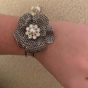 Flower bracelet cuff with pearl in the center.